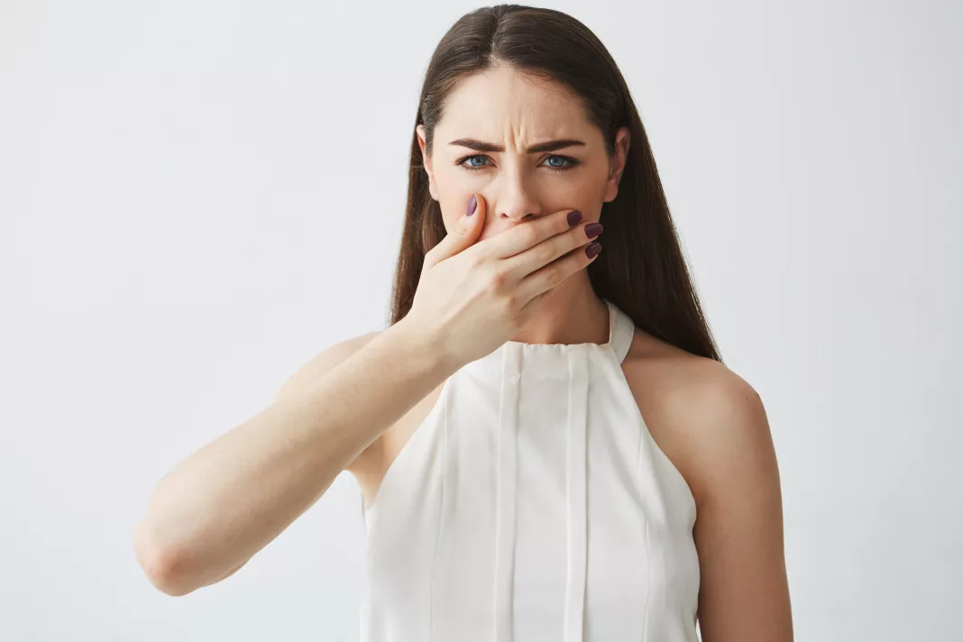 Vrouw houdt haar hand voor haar mond